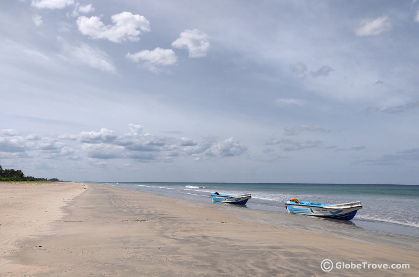 The sandy shores of Nilaveli beach with two white and blue boats docked on it is one of the gorgeous places to visit in Trincomalee