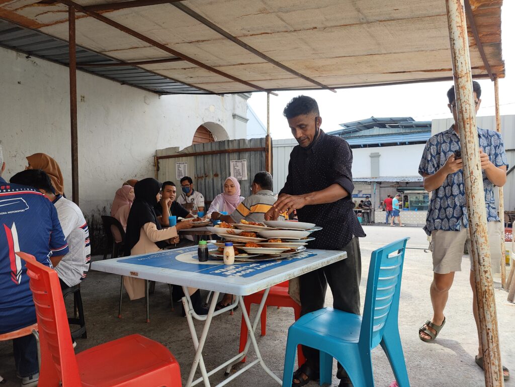 The iconic balancing act with the plates at Roti Canai Transfer road.