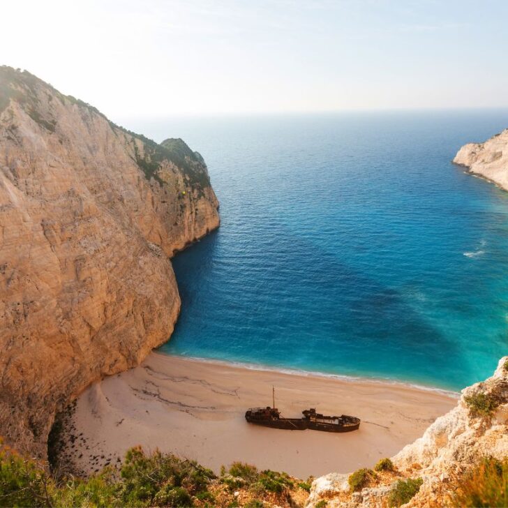 The limestone cliffs and the blue water makes the cheap islands in Greece so tempting.