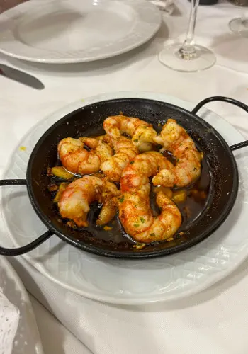Gambas Pil Pil is one of the simple tapas in Andalucia that is cooked using prawns, olive oil, garlic and paprika.