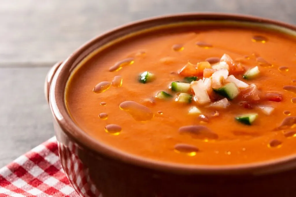 Cold tomato soup with toppings also known as Gazpacho is one of the best tapas in Andalucia on a hot summer day.