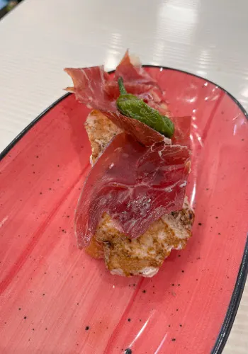 Serranito - A small sandwich topped with pork