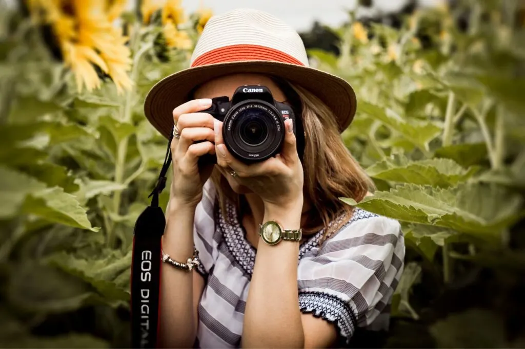 A lady clicking a photograph with a canon camera. You really can't have a Hawaii packing list without a camera.