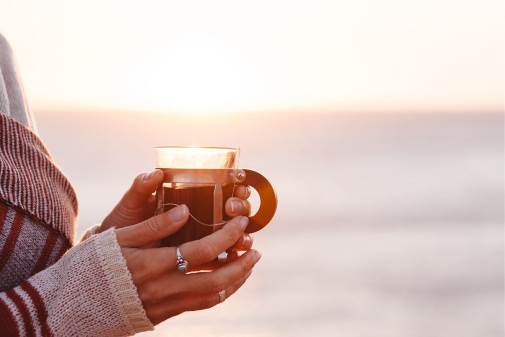 A lady with a light sweater and a cup of tea because every Hawaii packing list needs something to keep you warm.