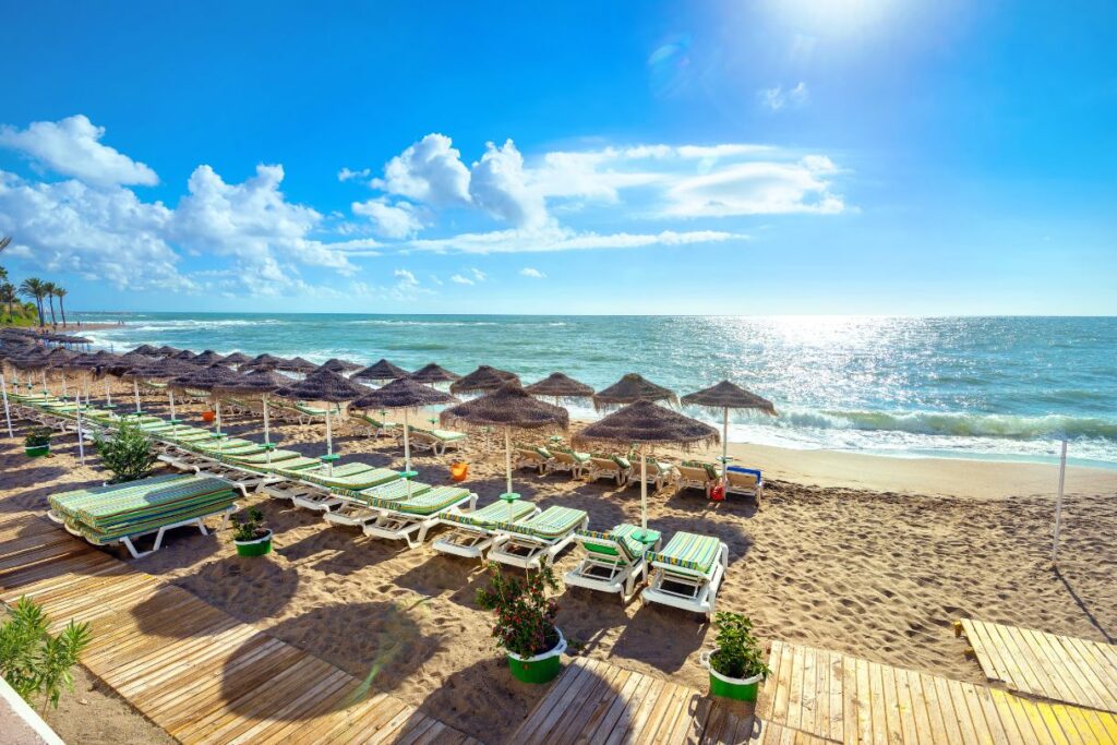 The beach with beach chairs, a boardwalk and the waves lapping at the shore is just one of the reasons why Malaga is worth a visit.