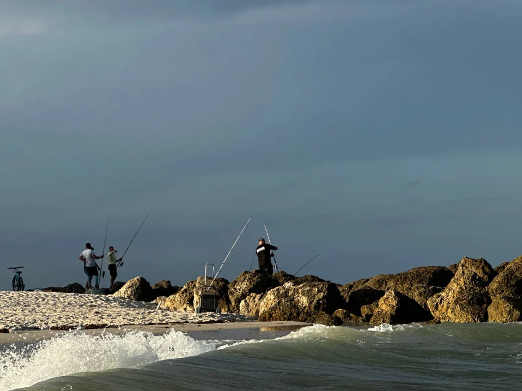 People fishing at the mid beach with the stormy background which is a sight that you will see sometime during your 3 days in Miami.