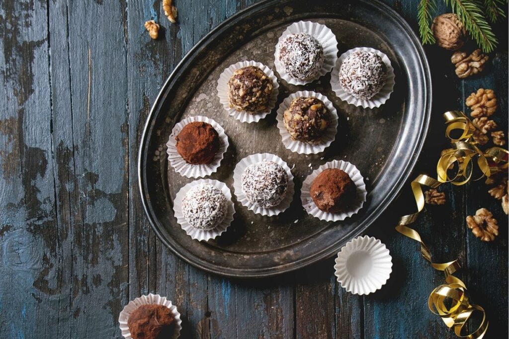 Different types of chocolate truffles arranged on a plate are the perfect Paris themed gifts for any Paris lover