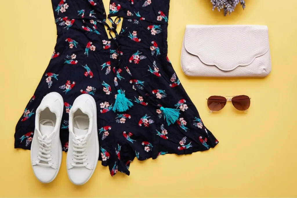 Black floral dress with a clutch and white shoes that are definitely things that I would suggest packing for Italy in summer