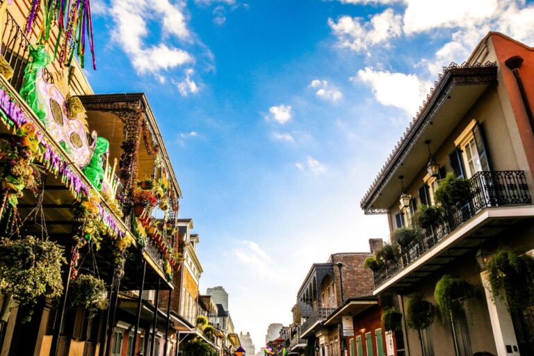 The buildings in New Orleans decked up for Mardi Gras. A lot of the New Orleans captions and quotes are about this festival.