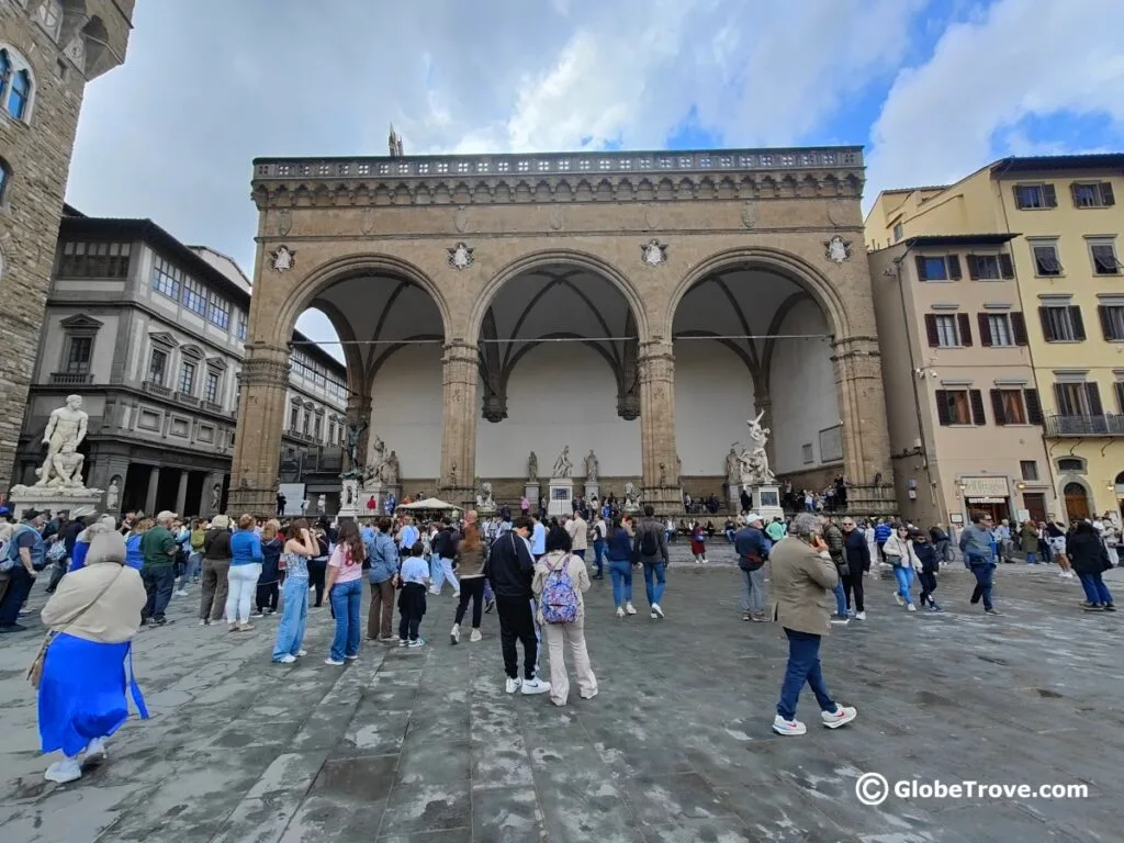 The crowds in front of the Logia dei Lanzi in Florence