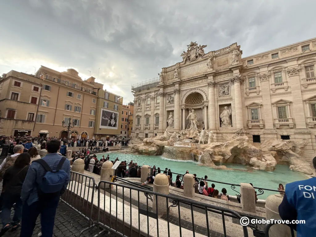 Crowds of people visiting the Trevi fountain
